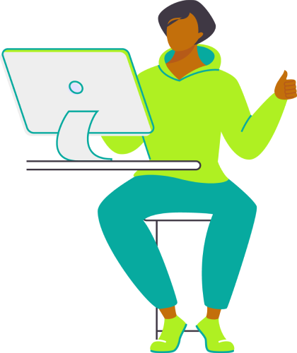 A woman seated at a desk, focused on her laptop, with a notepad and pen beside her.