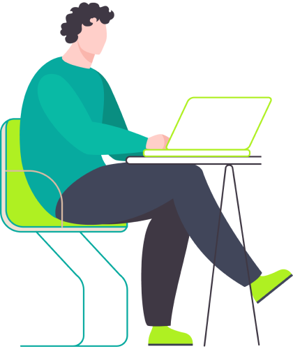 A woman seated at a desk, focused on her laptop, with a notepad and pen beside her.