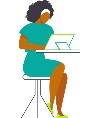 A woman seated at a desk, focused on her laptop, with a notepad and pen beside her.